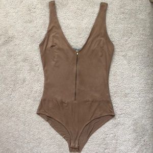 Tan bodysuit with gold zipper